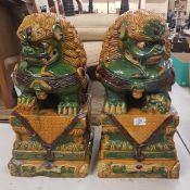 A pair of large Sancai enamelled stoneware Foo Dogs/Dogs of Fu, early 20th Century, 57cm in