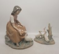 Two Nao figures, one of a girl feeding a goose and one of a group of geese (2).