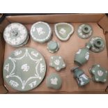 A collection of Wedgwood sage green jasper-ware items to include lidded boxes, candleholders, bud