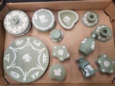 A collection of Wedgwood sage green jasper-ware items to include lidded boxes, candleholders, bud