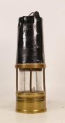 A Brass Miners Lamp with Painted Black upper Section, and padlocked lower section. Top is worn but