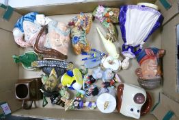A mixed collection of items to include character jugs, musical lady figures, Chinese lion dog,