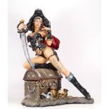 Large resin figure of female pirate sitting on treasure chest, height 50cm