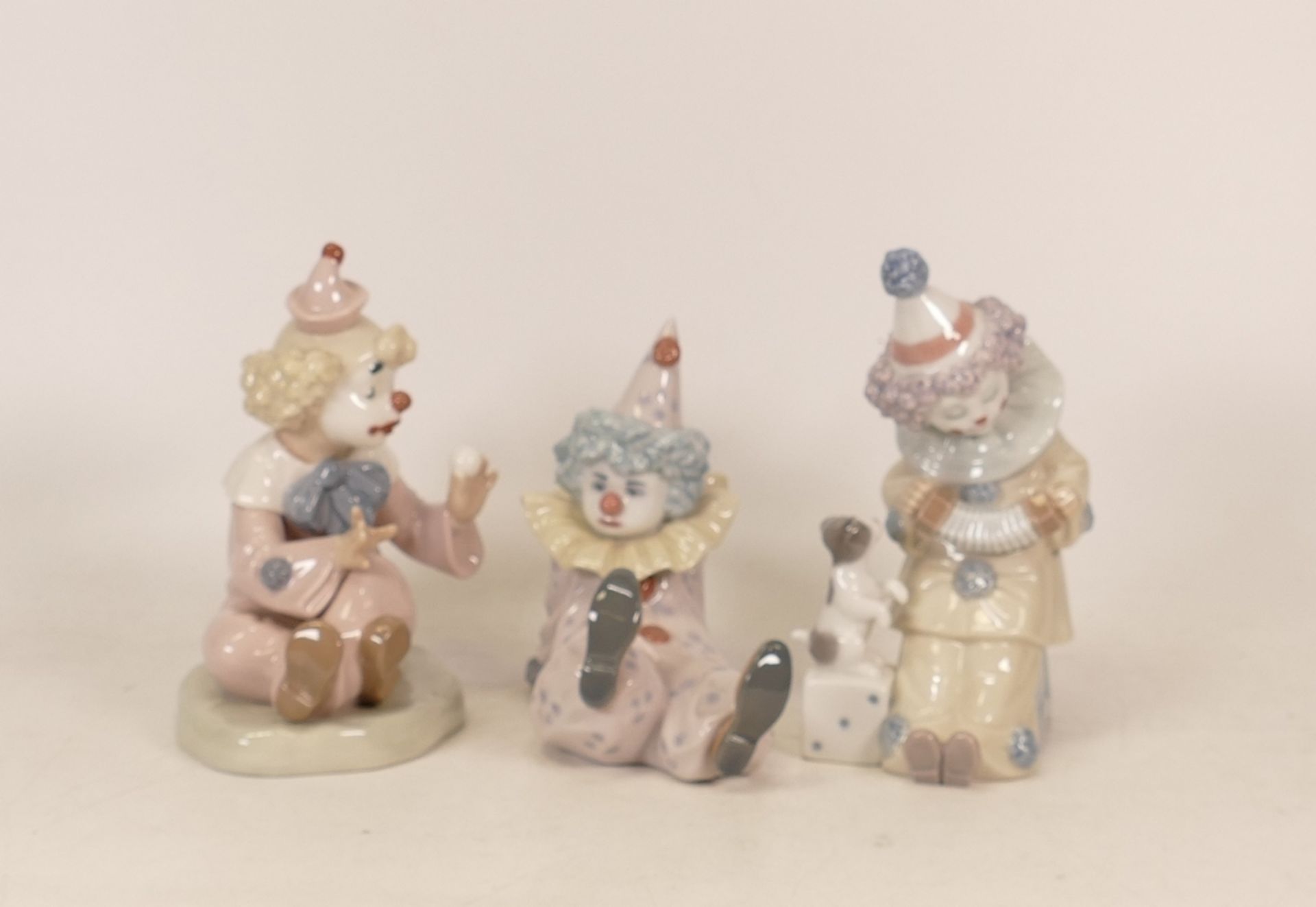 Lladro figures Pierrot with Puppy 5279 and Tired Friend 5812 together with Nao figure clown with