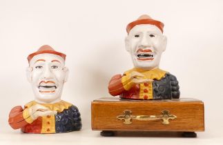 Two Painted Cast Iron Money Boxes of Jesters/Clowns. One mounted on a wood and brass base (