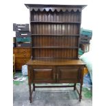 Early 20th dark Oak dresser stretchered two door base with plate rack above 122cm W x 211cm H