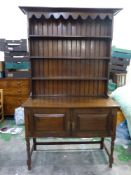 Early 20th dark Oak dresser stretchered two door base with plate rack above 122cm W x 211cm H