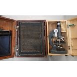 A cased student's microscope together with a vintage oak cased silk screen printing hand press (2).