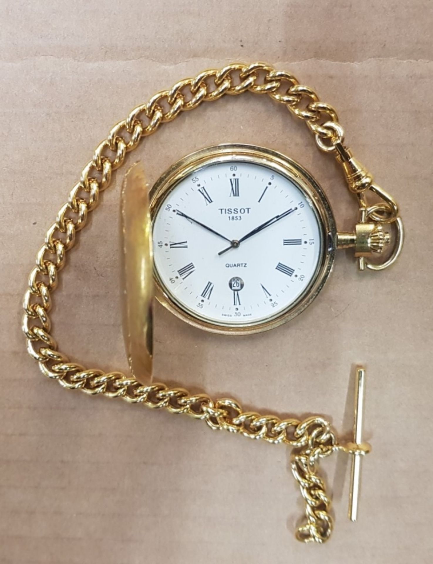 Tissot gold tone quartz pocket watch and chain.