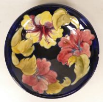 Moorcroft Hibiscus on Blue Ground Shallow Footed Bowl, chip to rim, diameter 24.5cm