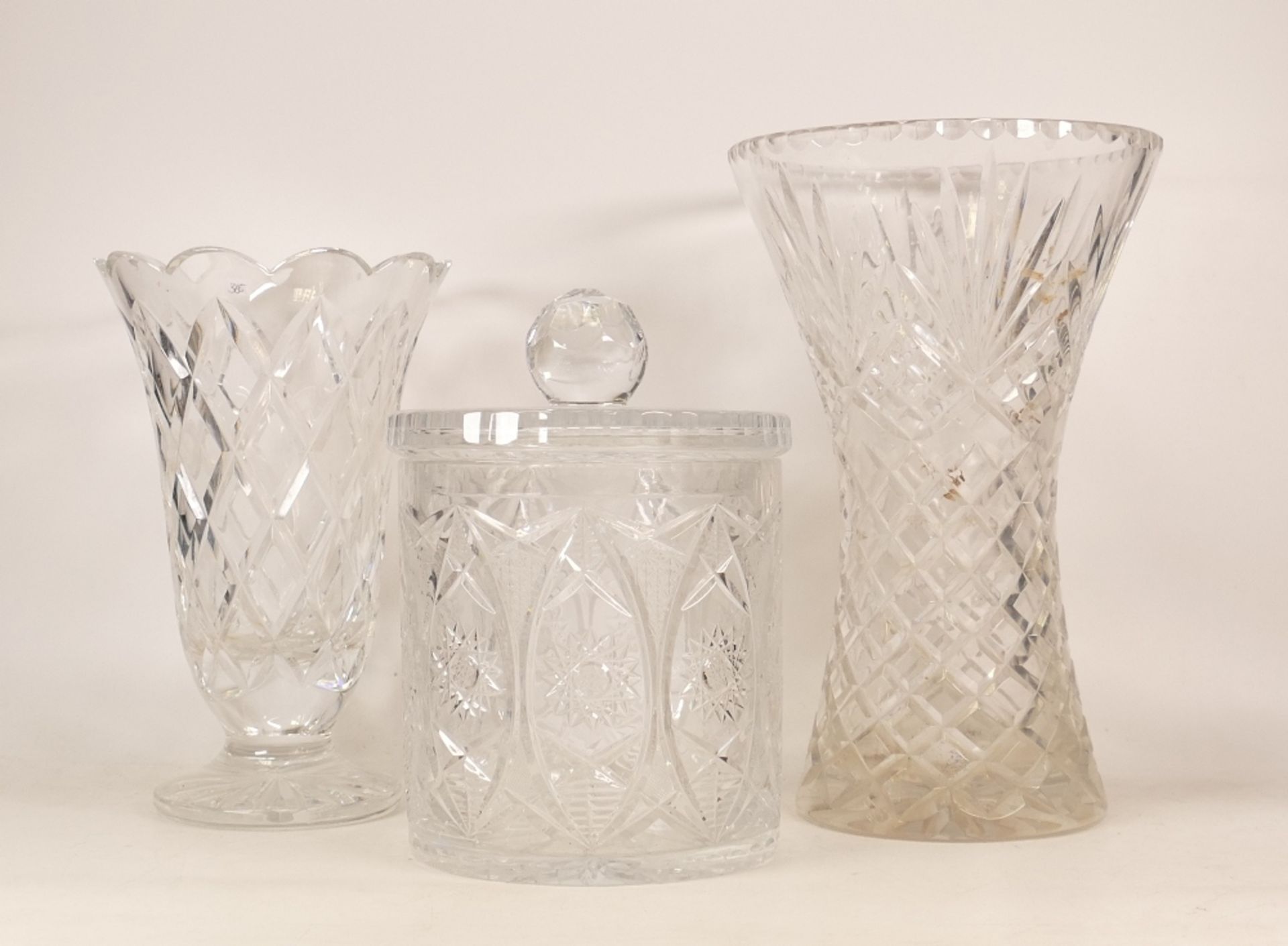 Large heavy glass vase together with footed vase and glass storage jar (3)