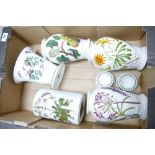 A collection of Portmeirion Botanic patterned items including vases, tea candle holders, storage jar