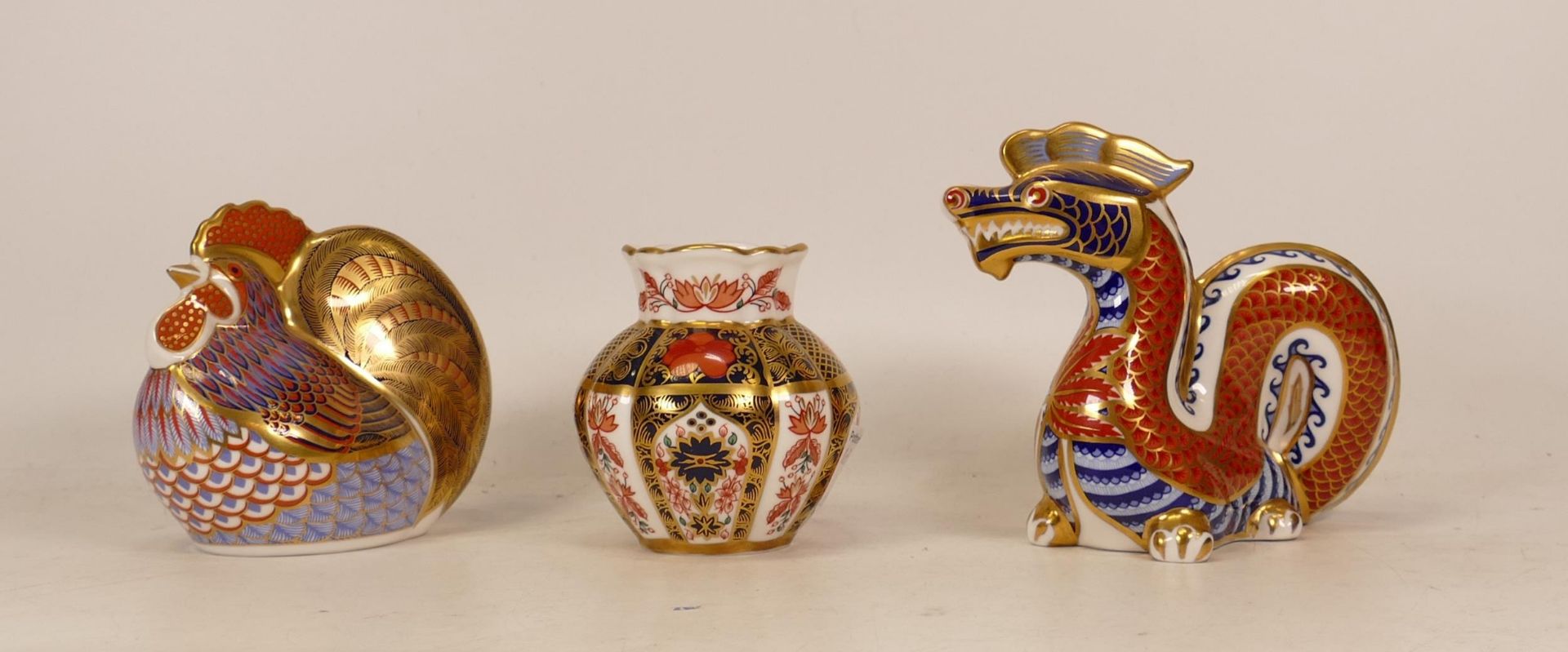 Three Royal Crown Derby Items to include Dragon Paperweight, Rooster Paperweight and a small Imari