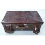 A Large Faux Crocodile Skin Suitcase. Partial Label to interior reads Singapore. Rust and Tarnish to
