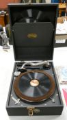 Vintage Triumph portable cased record player with some records.