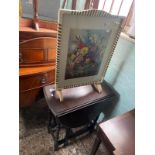 Dark oak drop leaf side table, together with a mid-century floral fire screen (2).