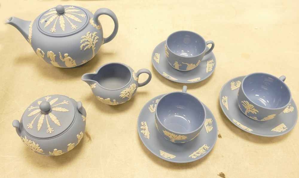 Wedgwood blue Jasper ware tea set including tea pot, 3 cups & saucers, sugar bowl & milk jug. (9)