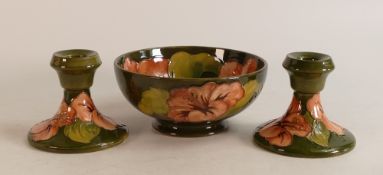 Moorcroft Hibiscus on green bowl and matching candlesticks. Diameter of bowl 16cm
