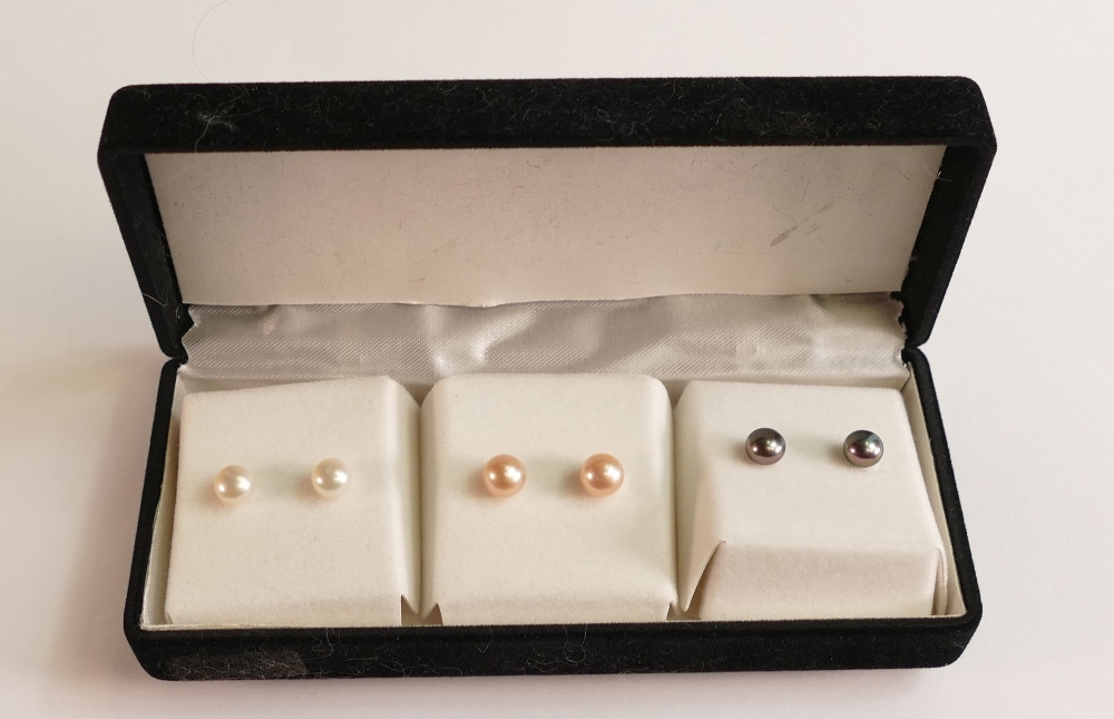 Three pairs of 9ct gold stud earrings.
