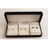 Three pairs of 9ct gold stud earrings.