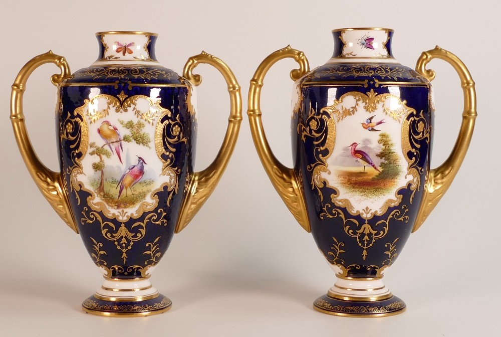 19th century Coalport pair of two handled vases, gilded all over & decorated with panels of flowers,