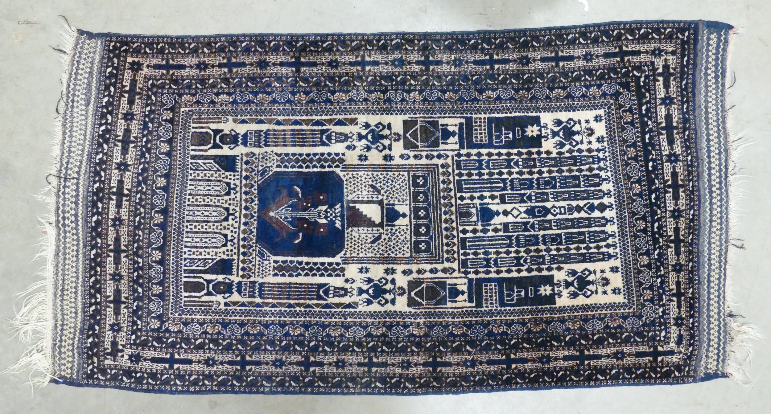 An Eastern Prayer Rug with Religious Architectural Patterns. Wear and...