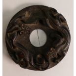 Oriental Bi-Disk with Carved Decoration of two mythical beasts in ouroboros style order. Repeating