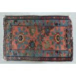 An Eastern Rug with Two Medallion Pattern in Red and Turquoise Colours. Wear and fraying noted.