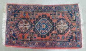 An Eastern Style Five Medallion Pattern Rug in Red and Turquoise Colours. Wear and Fraying Noted.