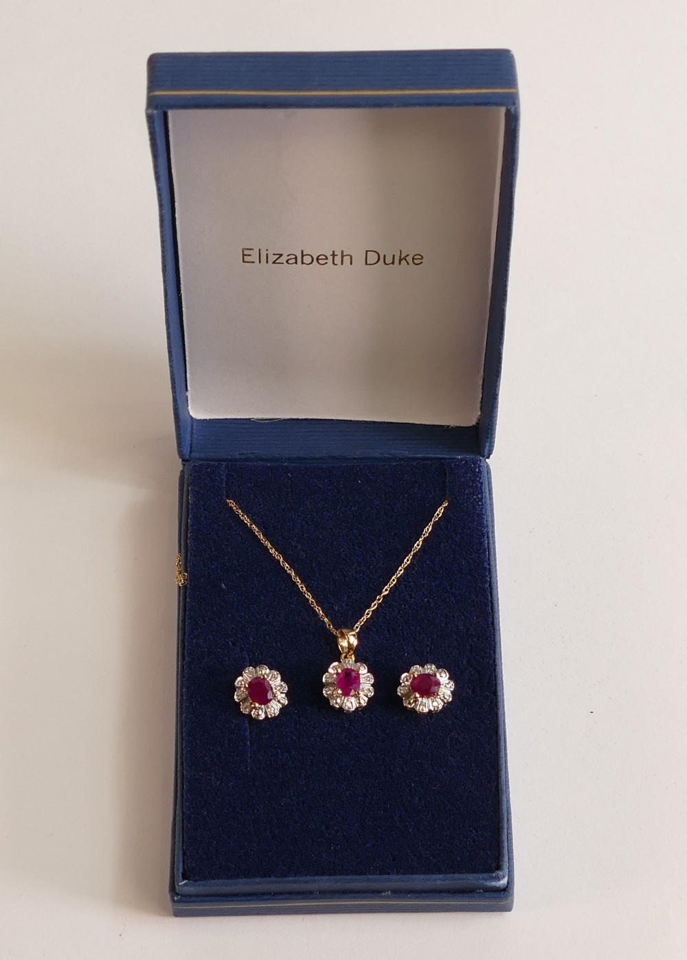 9ct gold ruby pendant, necklace and earrings, 3g. (4)