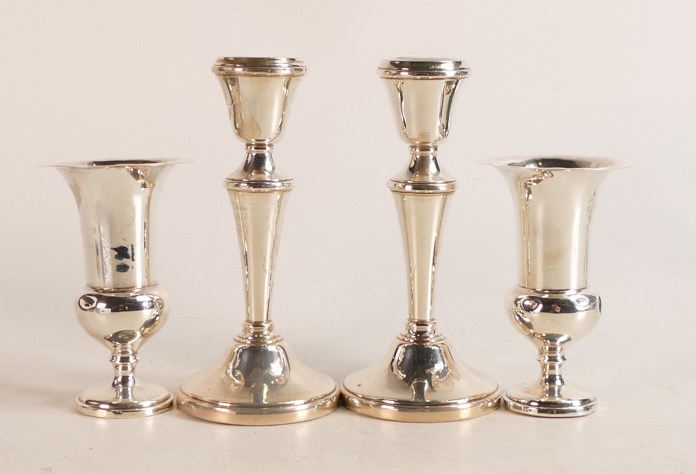 Pair of silver candlestick and a pair of silver vases, both UK hallmarked and with loaded bases.