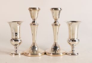 Pair of silver candlestick and a pair of silver vases, both UK hallmarked and with loaded bases.