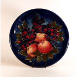 Moorcroft large charger decorated in the Finch and Berries design on dark blue ground, C1990, d.