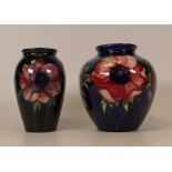Two Moorcroft Anemone on blue vases. Both A/F