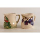 Two Moorcroft mugs in the Robin and Plum ( chip to top rim) designs. (2)