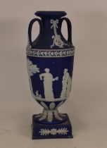 Wedgwood dip blue twin handled vase on base with classical scenes (handles a/f)