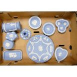 A collection of Wedgwood blue jasperware pin dishes , spill vase, plate, lidded boxes