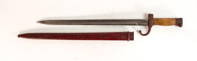 A WWII Japanese style bayonet with scabbard. Painted red with wooden grips. Length incl. scabbard: