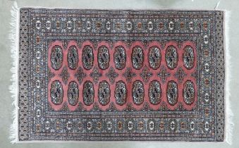 A Red Uzbek Bokhara Style Rug. Wear and Fraying Noted. Length: 162cm Width: 97cm