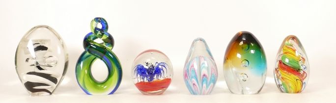 A collection of glass paperweights to include egg shaped paperweight with swirls and bubbles and