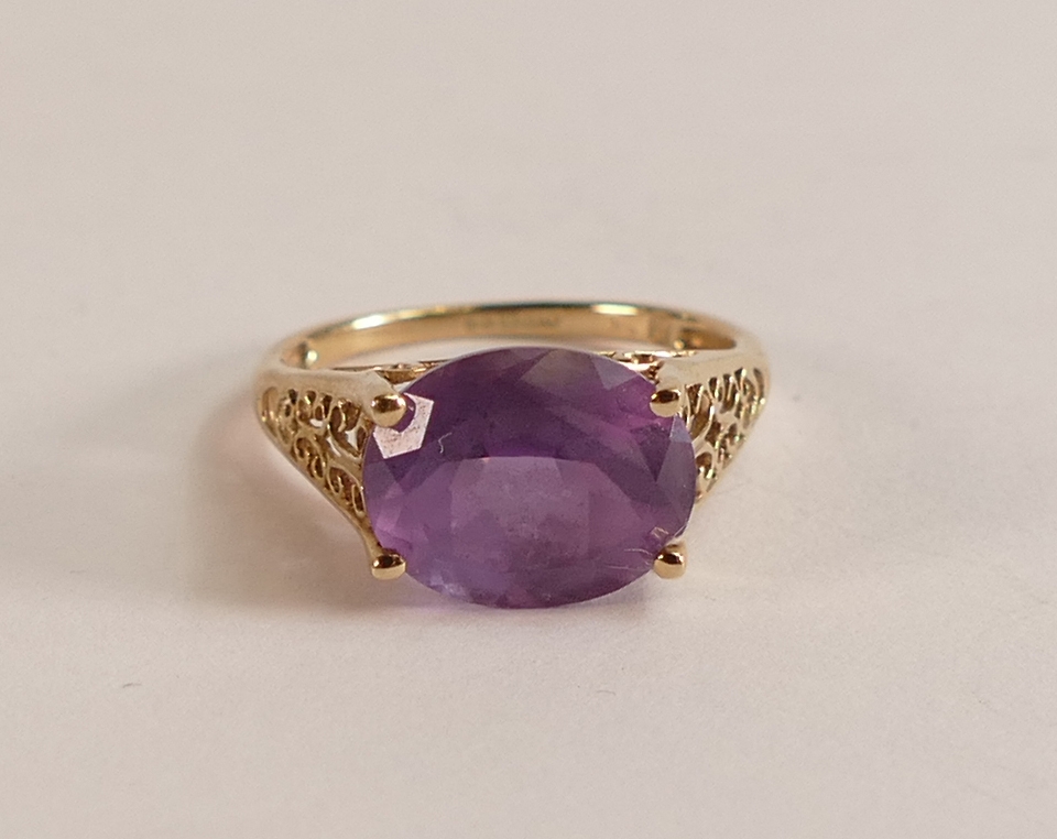 9ct gold ladies dress ring set with oval purple stone, size K, 2.1g.