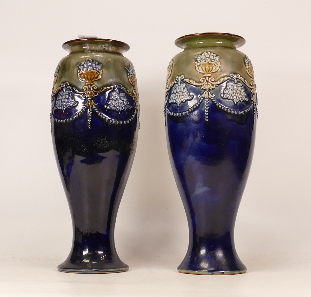 A pair of Royal Doulton Lambeth stoneware vases classical floral decorated . Height 29cm (2)