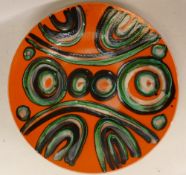 Poole pottery charger on orange ground . 36cm diameter