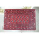 A Red Afghan Floor Rug. Wear and fraying present. Length: 208cm Width: 130cm