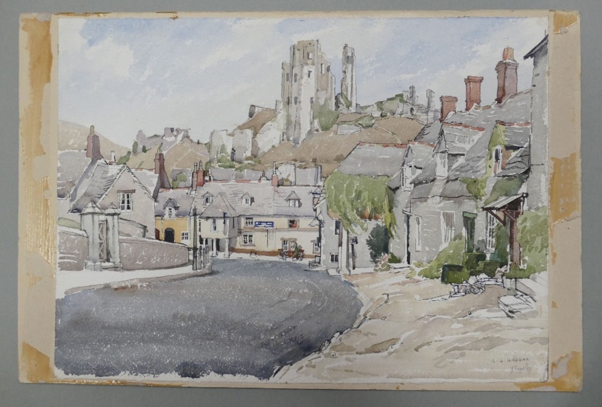 Reginald George HAGGAR (1905–1988) Village Scene with Castle Ruins on a Hill. Signed and dated lower