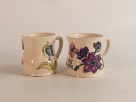 Two Moorcroft mugs to include bluebell (crazed) and Mcc 1998 (2)