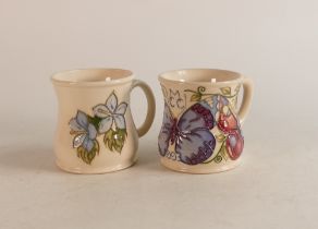 Two Moorcroft mugs to include Blue Clematis and M.C.C 1993 (2)