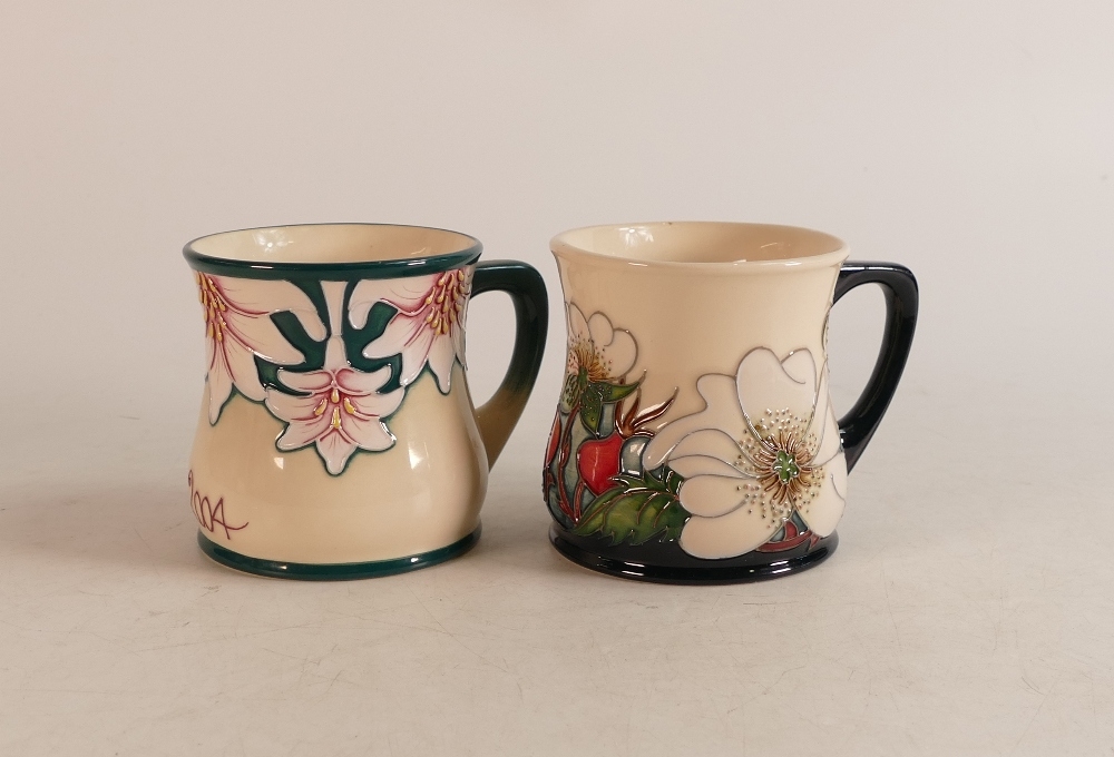 Two Moorcroft Mugs to include mug of the year 2004 and mug decorated in wild flowers on blue and