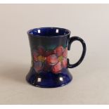 Large Moorcroft mug decorated in the Clematis pattern, height 10cm