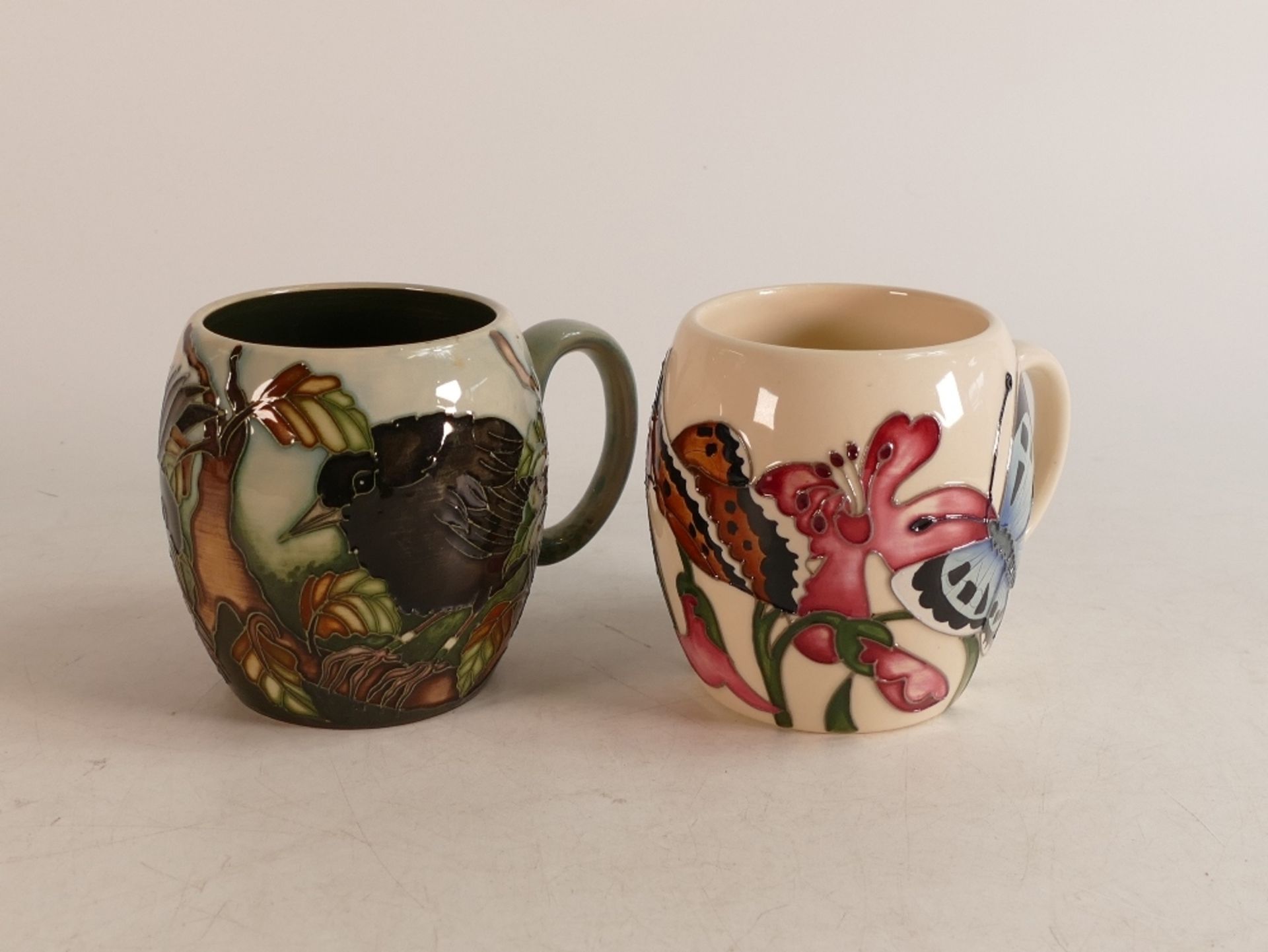 Two Moorcroft mugs to include Blackbird and butterflies & moths (2)